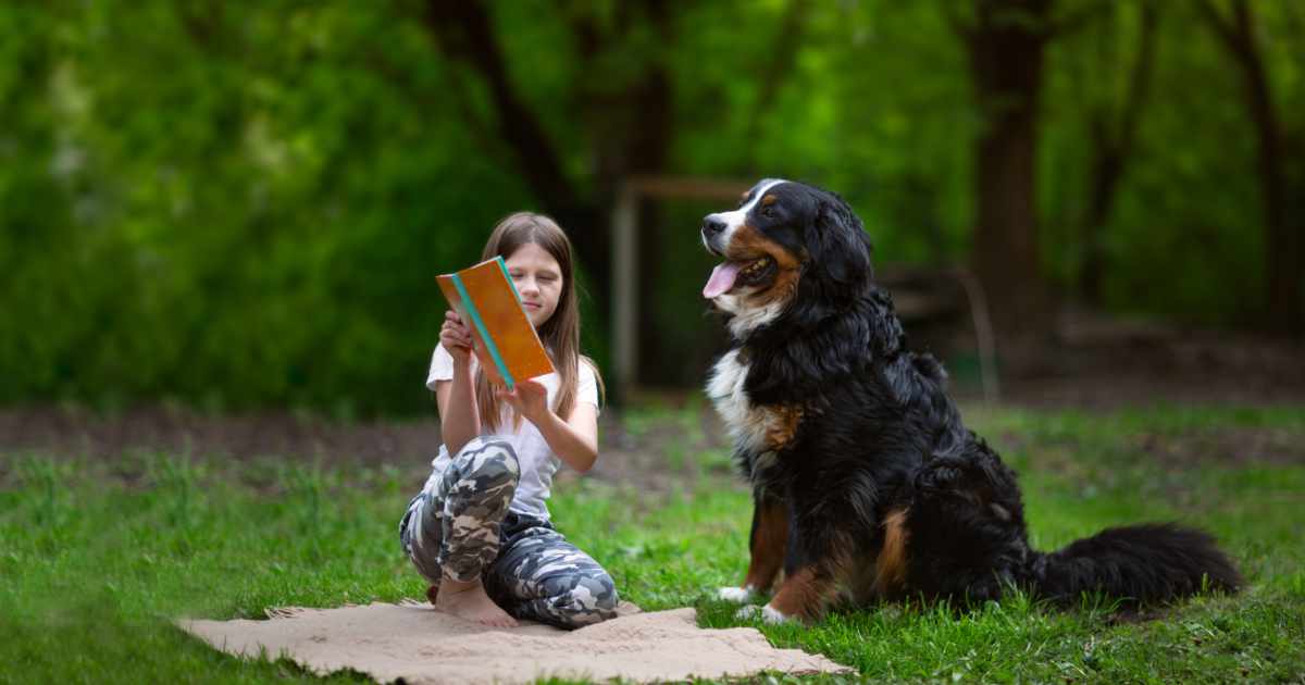 Girl reading with dog Girl reading with dog